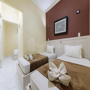 Voodi või voodid majutusasutuse Hotel 78 Parapat Mitra RedDoorz toas