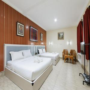 Voodi või voodid majutusasutuse Hotel 78 Parapat Mitra RedDoorz toas