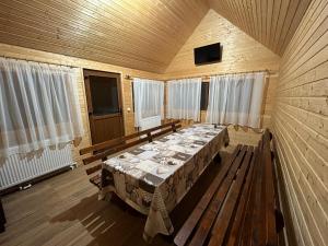 a dining room with a table in a wooden room at Cabana Lazea in Gîrda de Sus