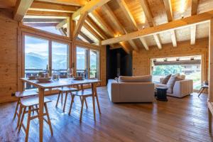 a living room with a table and chairs in a house at Base Camp COSY chalet 4 personnes in Les Mosses