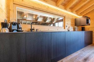 a kitchen with blue cabinets and a window at Base Camp COSY chalet 4 personnes in Les Mosses +12 photos