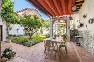 an outdoor patio with a table and chairs at Carmen San Andrés in Granada