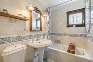 a bathroom with a sink and a toilet and a tub at Carmen San Andrés in Granada +30 photos