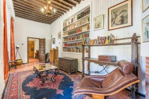 a living room with a leather chair and a table at Carmen San Andrés in Granada