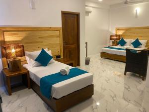 Ένα ή περισσότερα κρεβάτια σε δωμάτιο στο Trinco Beach Resort