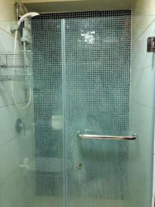 a shower with a glass door in a bathroom at Jojies Crib Horizons101 Studio in Cebu City +6 photos