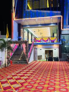 a building with a red carpet in front of a staircase at The Four Seasons Hotel in Sultānpur