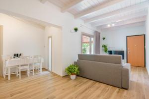 a living room with a couch and a table at Guest House Deidda - TS ROOMS B&B in San Sperate