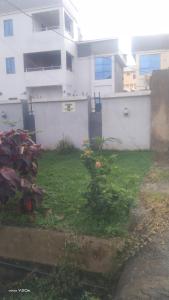 a yard in front of a white building at Omeroi Guest House in Kubwa