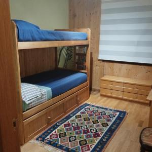a bedroom with bunk beds with a rug at Lunar in Castiello de Jaca +15 photos