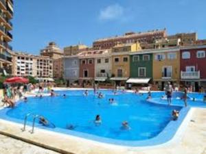 a large swimming pool with many people in it at Little Venice apartment in Alboraya