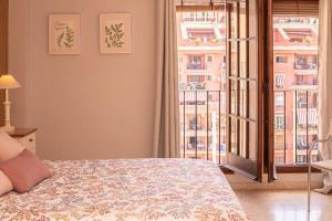 a bedroom with a bed and a large window at Little Venice apartment in Alboraya +28 photos