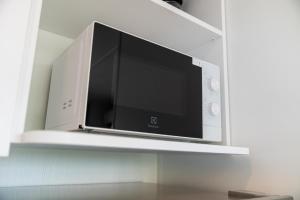 a flat screen tv sitting on a shelf at I Campi Wine Relais Mobile Homes in Ronchi