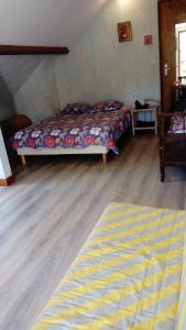 a bedroom with two beds and a wooden floor at Aou Routé in Auriébat