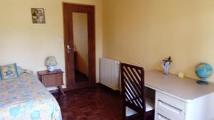 a bedroom with a desk and a bed and a table and chair at Aou Routé in Auriébat
