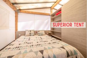 ein Schlafzimmer mit einem Bett in einem Zimmer in der Unterkunft Glamping Tents | Losinj | Camp Čikat in Mali Lošinj
