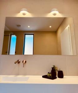 a bathroom with a mirror and a sink at Mansion Hvar in Malo Grablje