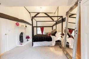 a bedroom with a large bed and a mirror at Dorney Windsor Legoland 5 Star Stay for upto 14 guests in Dorney