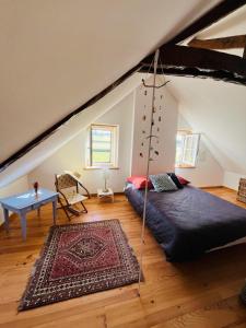a bedroom with a bed in the attic at La Maison Poésie in Blay