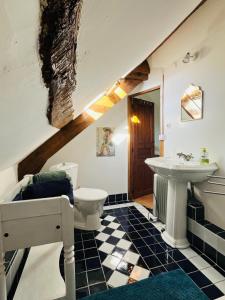 a bathroom with a sink and a toilet at La Maison Poésie in Blay
