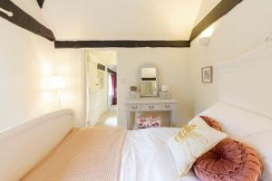 a bedroom with a white bed and a dressing table at Dorney Windsor Legoland 5 Star Stay for upto 14 guests in Dorney +96 photos