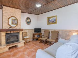 a living room with a couch and a fireplace at Holiday Home Rural Cacin by Interhome in Cacin