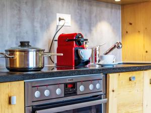 eine Küche mit Herd und Topf drauf in der Unterkunft Apartment la Ferme de Sandra F0 by Interhome in Nendaz + 23 Fotos
