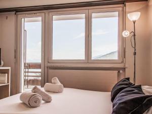 a bedroom with a bed with towels on it at Apartment Valaisia 34A by Interhome in Nendaz +22 photos