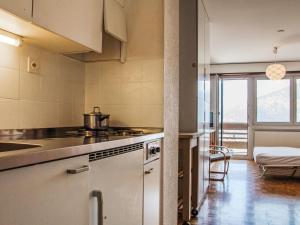a kitchen with a sink and a stove at Apartment Valaisia 34A by Interhome in Nendaz
