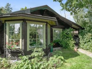 a house with windows and plants in the yard at Chalet Rindö by Interhome in Vaxholm