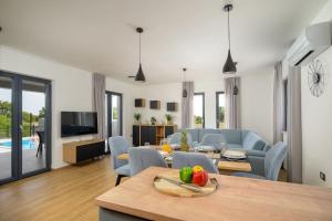 a living room with a couch and a table with fruit at Villa Kama by IstriaLux in Juršići