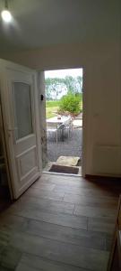 an open door leading to a patio with a table at Au Petit Galop in Nassiet