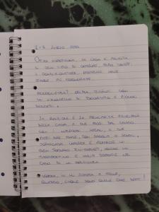 a notebook with handwriting on the pages at Dimora del Commendatore in Pozzallo