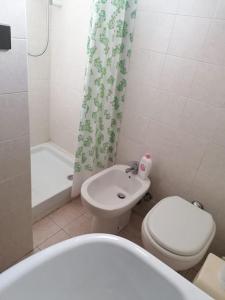 a bathroom with a white toilet and a sink at La casa nel borgo in Orsogna +11 photos
