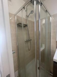 a shower with a glass door in a bathroom at Nice flat St Germain en Laye centre 30 minutes to Paris in Saint-Germain-en-Laye +13 photos