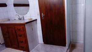 a bathroom with a sink and a mirror and a shower at Aou Routé in Auriébat