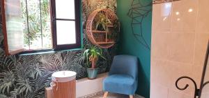 a room with a blue chair and a plant at Adorable maison cévenole in Bez-et-Esparon +52 photos