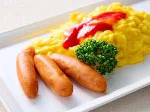 a plate of food with carrots broccoli and scrambled eggs at Comfort Hotel Nara in Nara