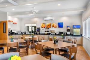 a restaurant with tables and chairs and a counter at Comfort Inn & Suites Susanville in Susanville