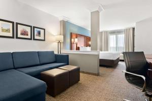 a hotel room with a couch and a bed at Comfort Suites Rensselaer near Fair Oaks in Rensselaer +39 photos