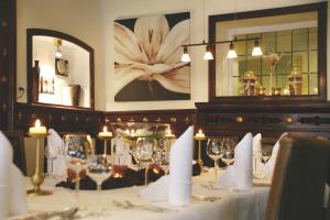 a dining room with a table with wine glasses at Hotel Waldecker Hof in Willingen