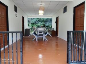 a table and chairs in the middle of a room at Bilik Umar in Gerik