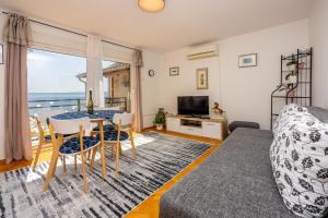 a bedroom with a bed and a table and chairs at Mudrovcic in Novi Vinodolski