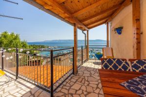 a balcony with a view of the water at Mudrovcic in Novi Vinodolski