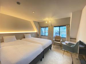 A bed or beds in a room at THE MOON Atami