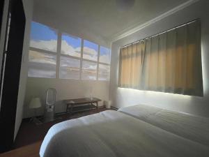 A bed or beds in a room at THE MOON Atami