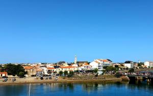 a city with a bridge over a body of water at Appartement sur Port - 78m2 Balcon in Saint-Gilles-Croix-de-Vie
