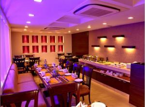 a dining room with a long table with purple lighting at Hotel Florence Inn, Karol Bagh, New Delhi, 2 Min from Metro in New Delhi