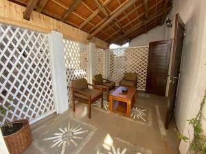 a room with chairs and a table and a door at M'Serenity Guest House in Antananarivo