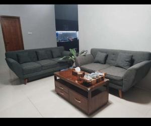 a living room with a couch and a coffee table at Villa Diva Sandik in Midang